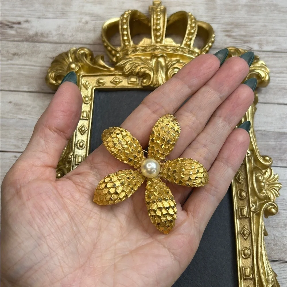 Vintage BSK gold-tone textured flower brooch with a faux pearl center.